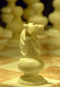 Close-up-of-marble-chess-set-with-knight-advancing-205x300